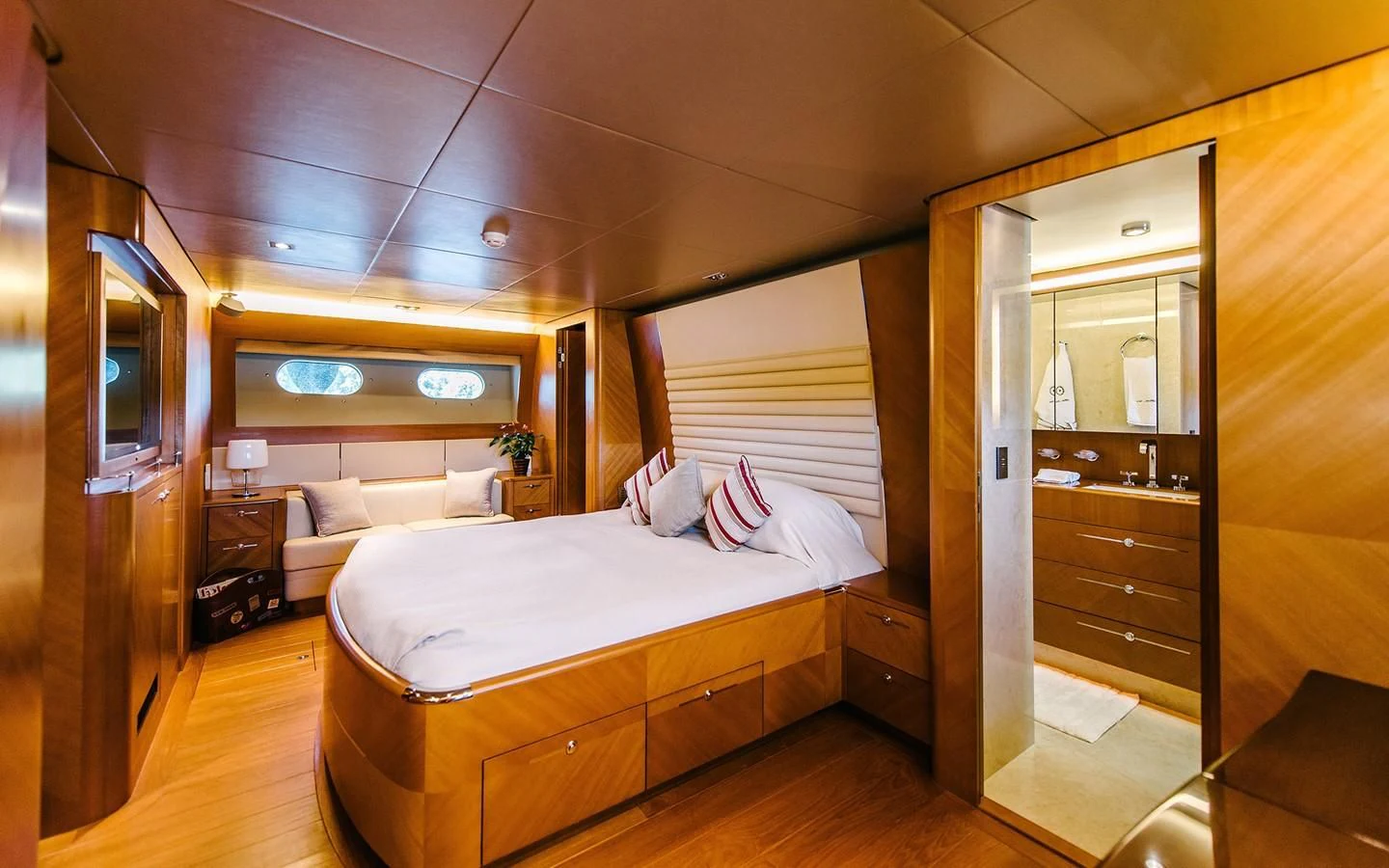a bedroom with a bed and a mirror aboard CARPE DIEM Yacht for Sale