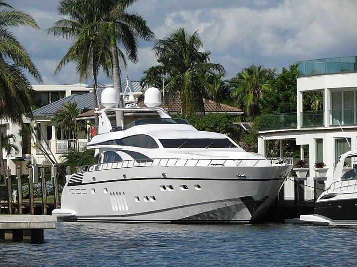 a white yacht docked at a pier aboard CARPE DIEM Yacht for Sale