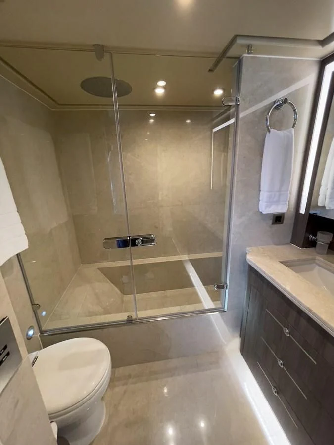 a bathroom with a glass shower aboard CARPE DIEM Yacht for Sale