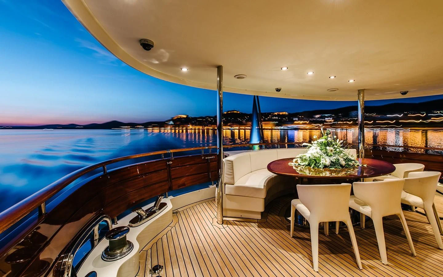 a large room with a table and chairs and a large body of water aboard CARPE DIEM Yacht for Sale