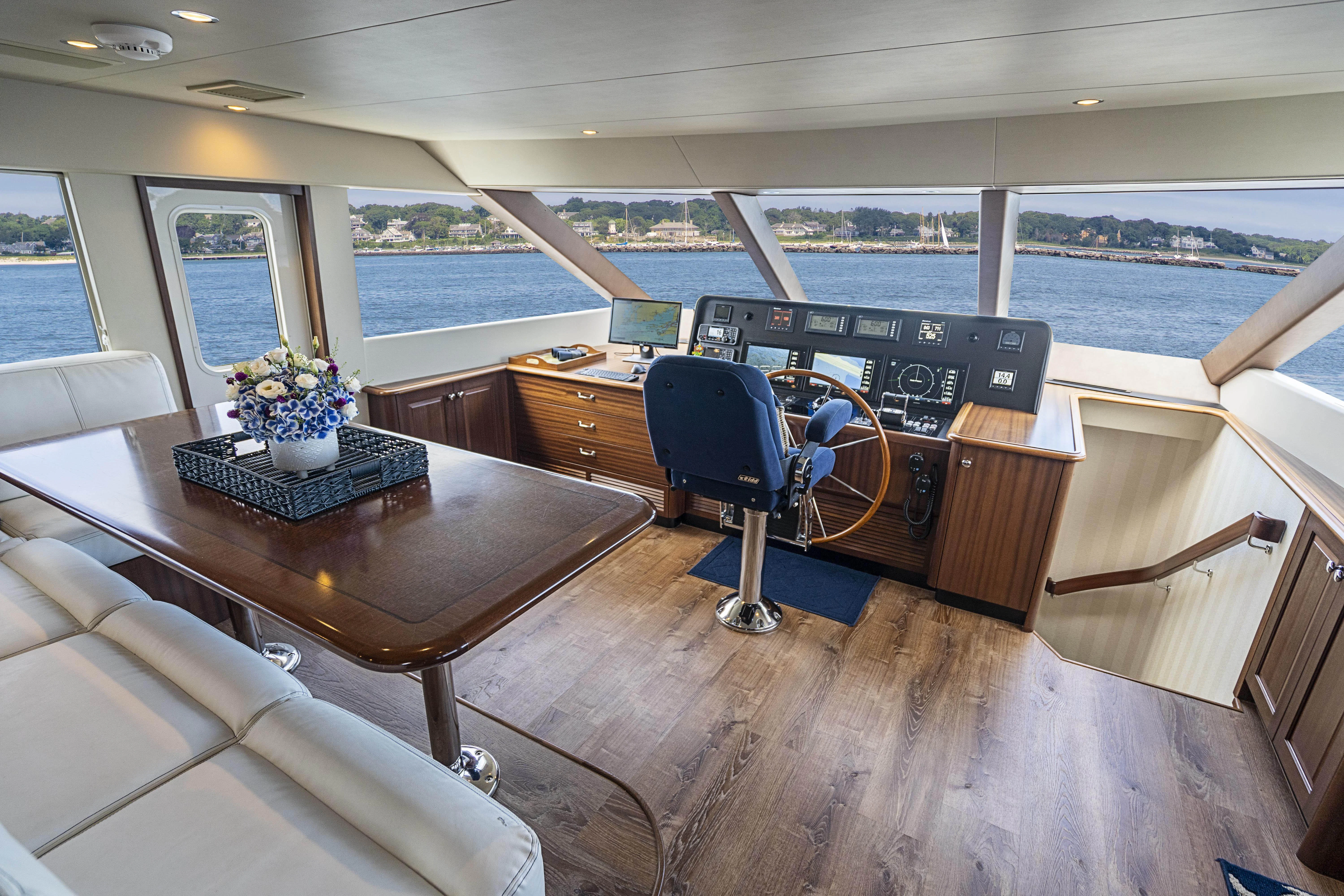 a room with a piano and a table and chairs aboard CARPE DIEM Yacht for Sale