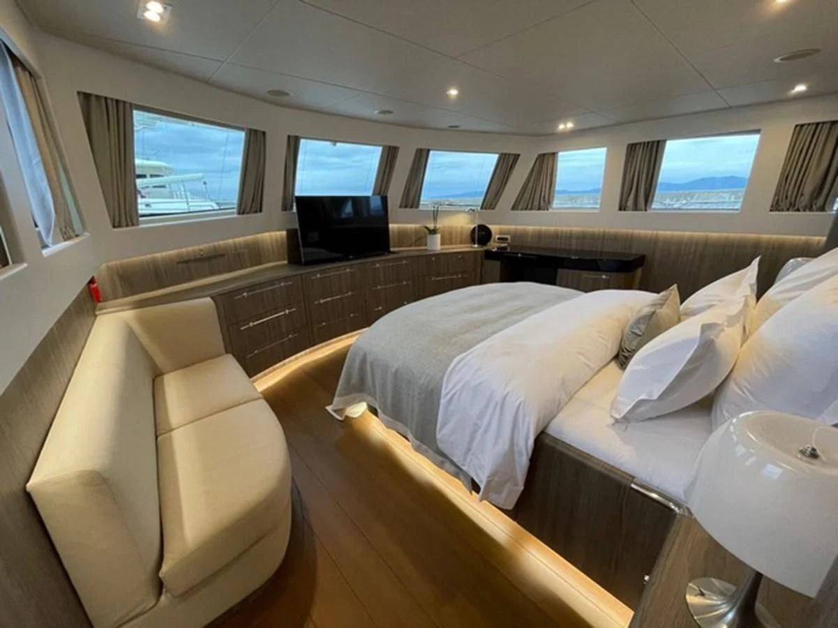 a room with a bed and a television aboard CARPE DIEM Yacht for Sale