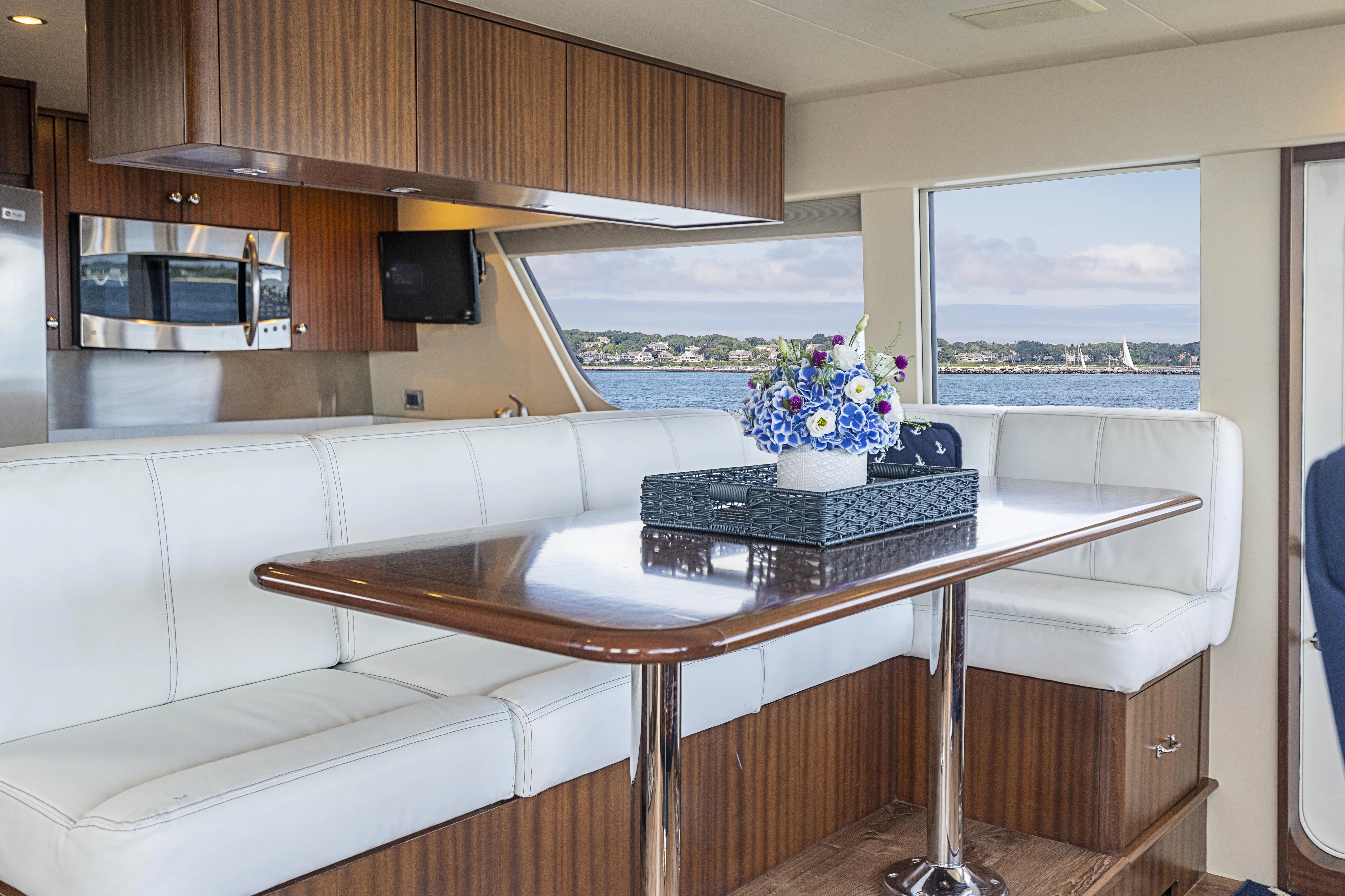 a room with a table and chairs aboard CARPE DIEM Yacht for Sale