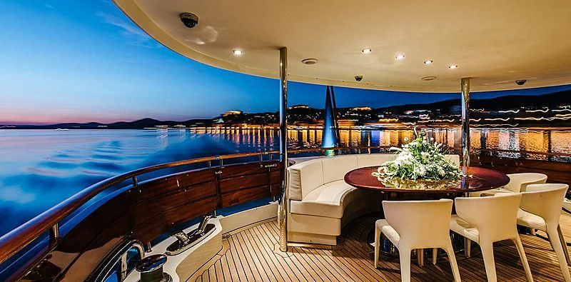 a large pool with a table and chairs aboard CARPE DIEM Yacht for Sale