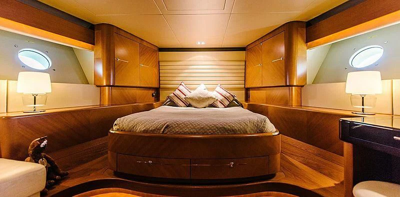 a room with a bed and a lamp aboard CARPE DIEM Yacht for Sale