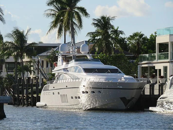 a white boat docked at a pier aboard CARPE DIEM Yacht for Sale