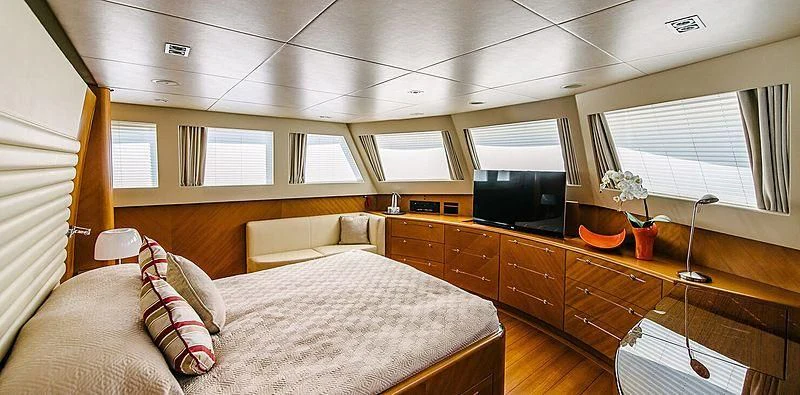 a bedroom with a bed and a tv aboard CARPE DIEM Yacht for Sale