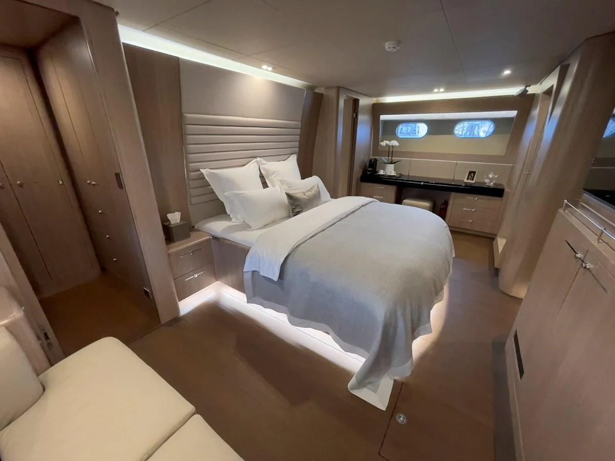 a room with a bed and a desk aboard CARPE DIEM Yacht for Sale