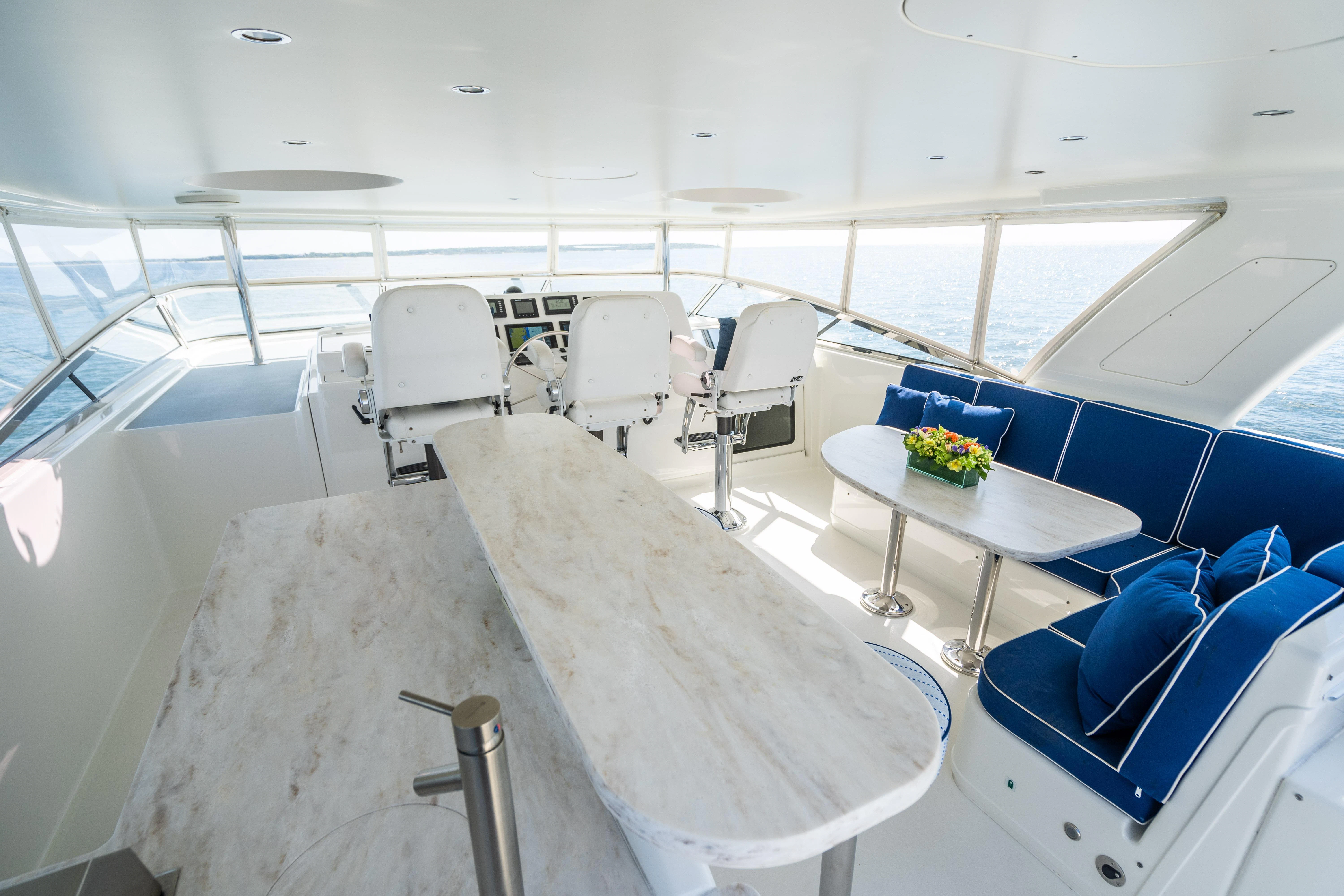 a large white yacht with chairs and tables aboard CARPE DIEM Yacht for Sale