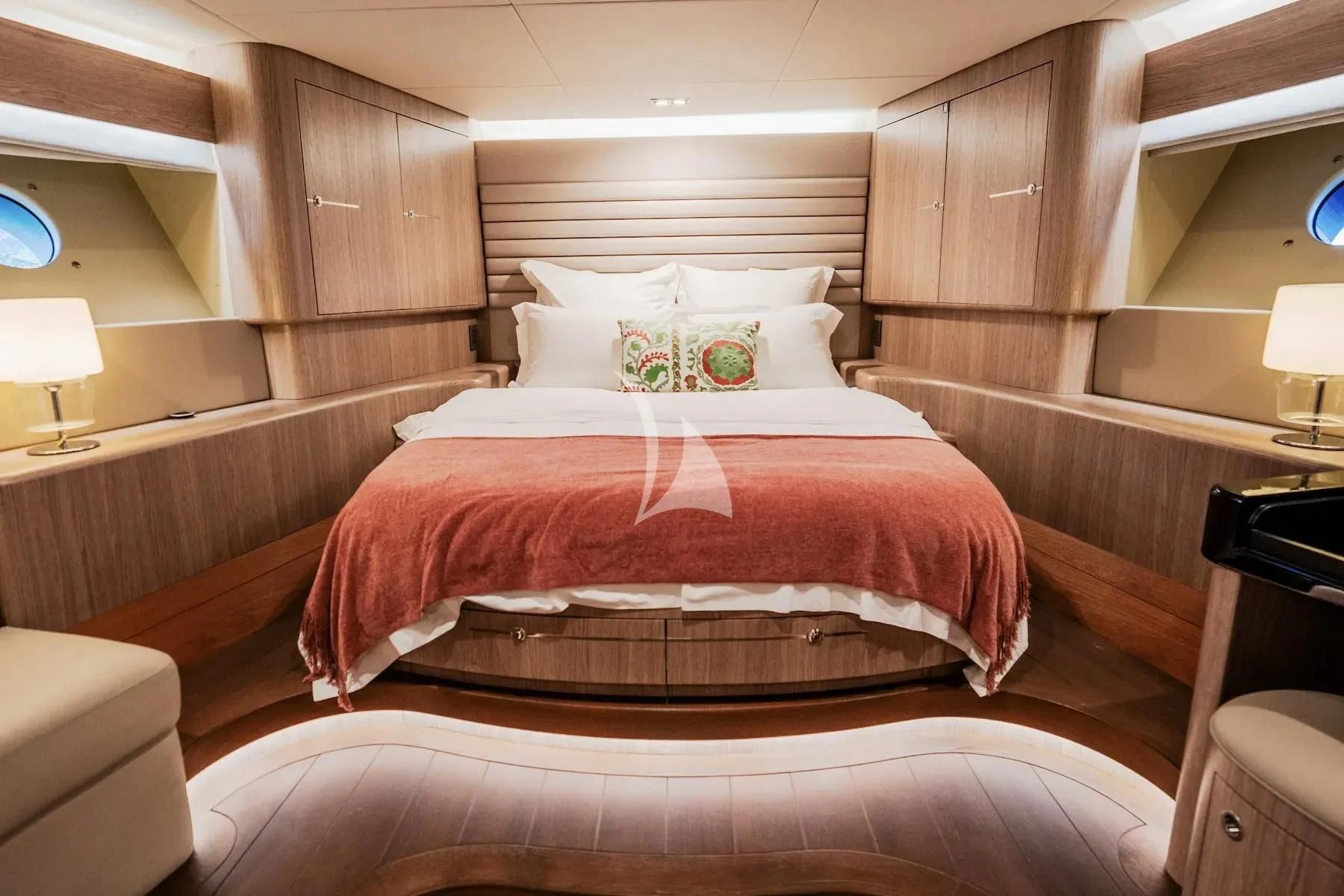 a bed with a red blanket aboard CARPE DIEM Yacht for Sale