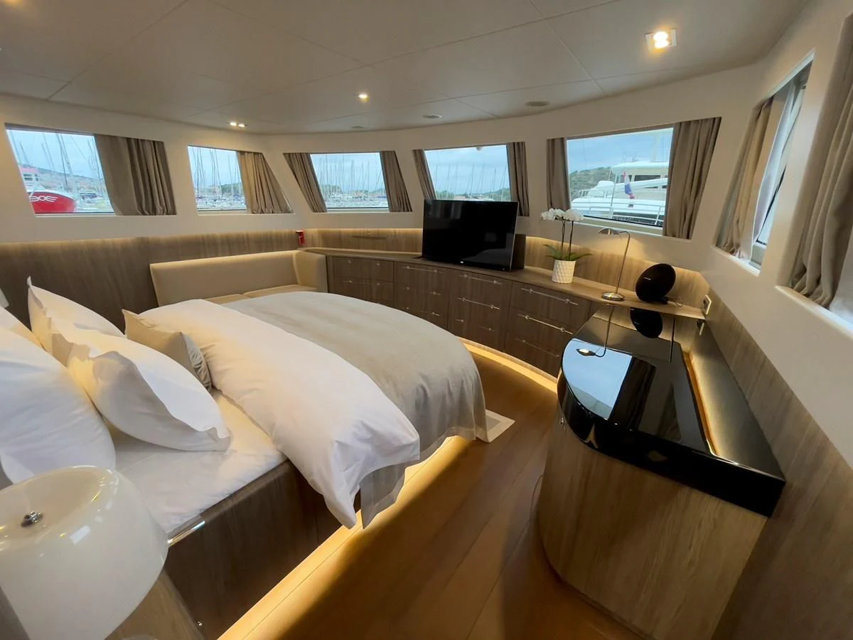 a room with a bed and a desk aboard CARPE DIEM Yacht for Sale