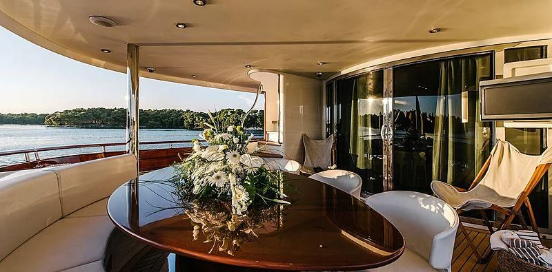 a table with flowers on it aboard CARPE DIEM Yacht for Sale