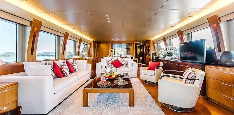 a living room with a white couch and a television aboard CARPE DIEM Yacht for Sale