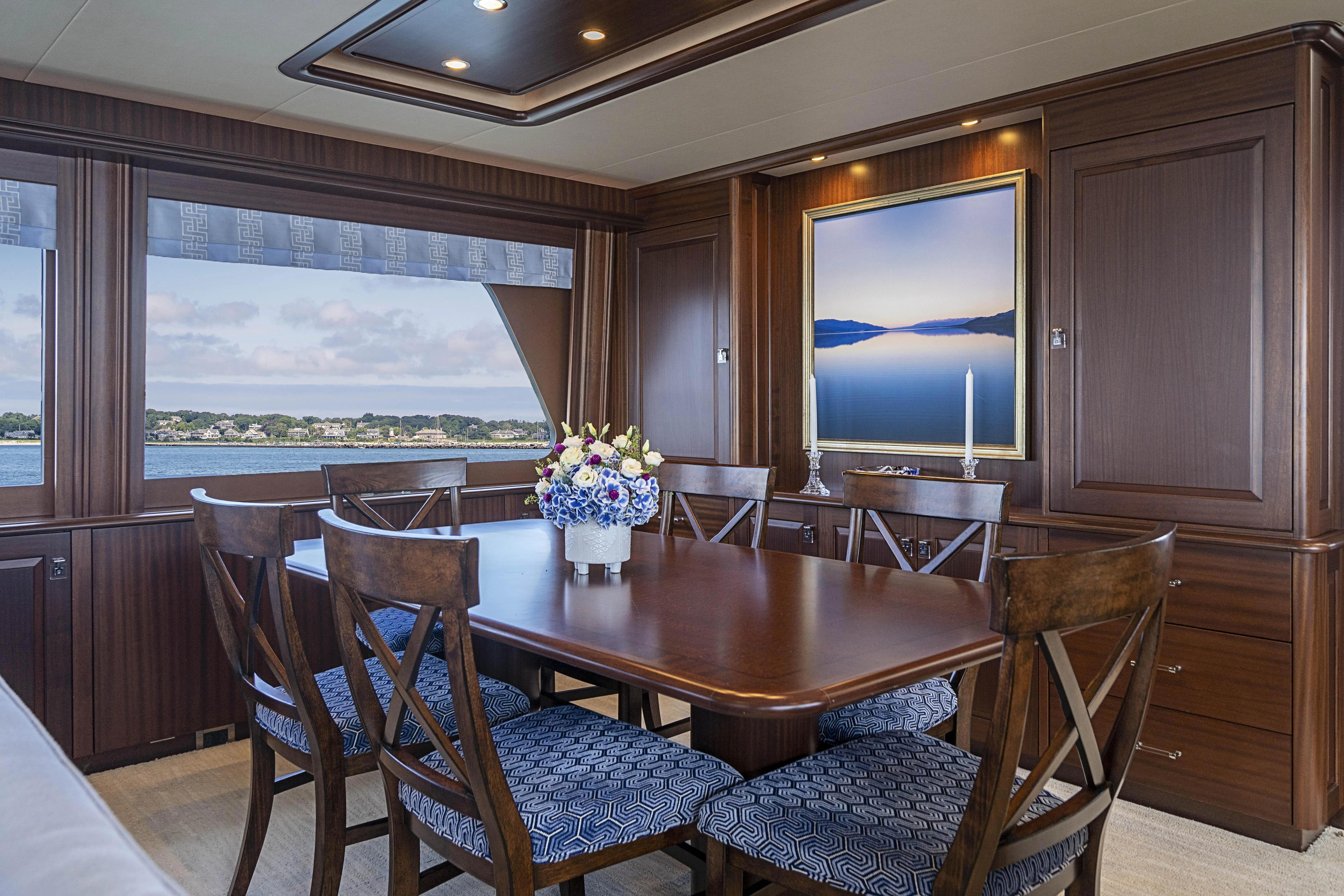 a room with a table chairs and a tv aboard CARPE DIEM Yacht for Sale