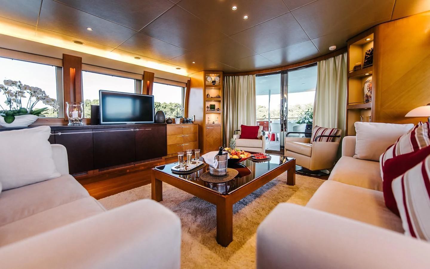 a living room with a tv and furniture aboard CARPE DIEM Yacht for Sale