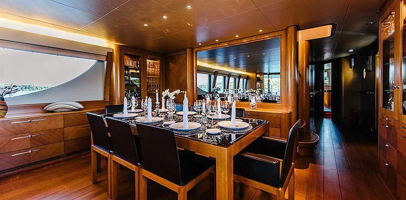 a dining room with a table and chairs aboard CARPE DIEM Yacht for Sale