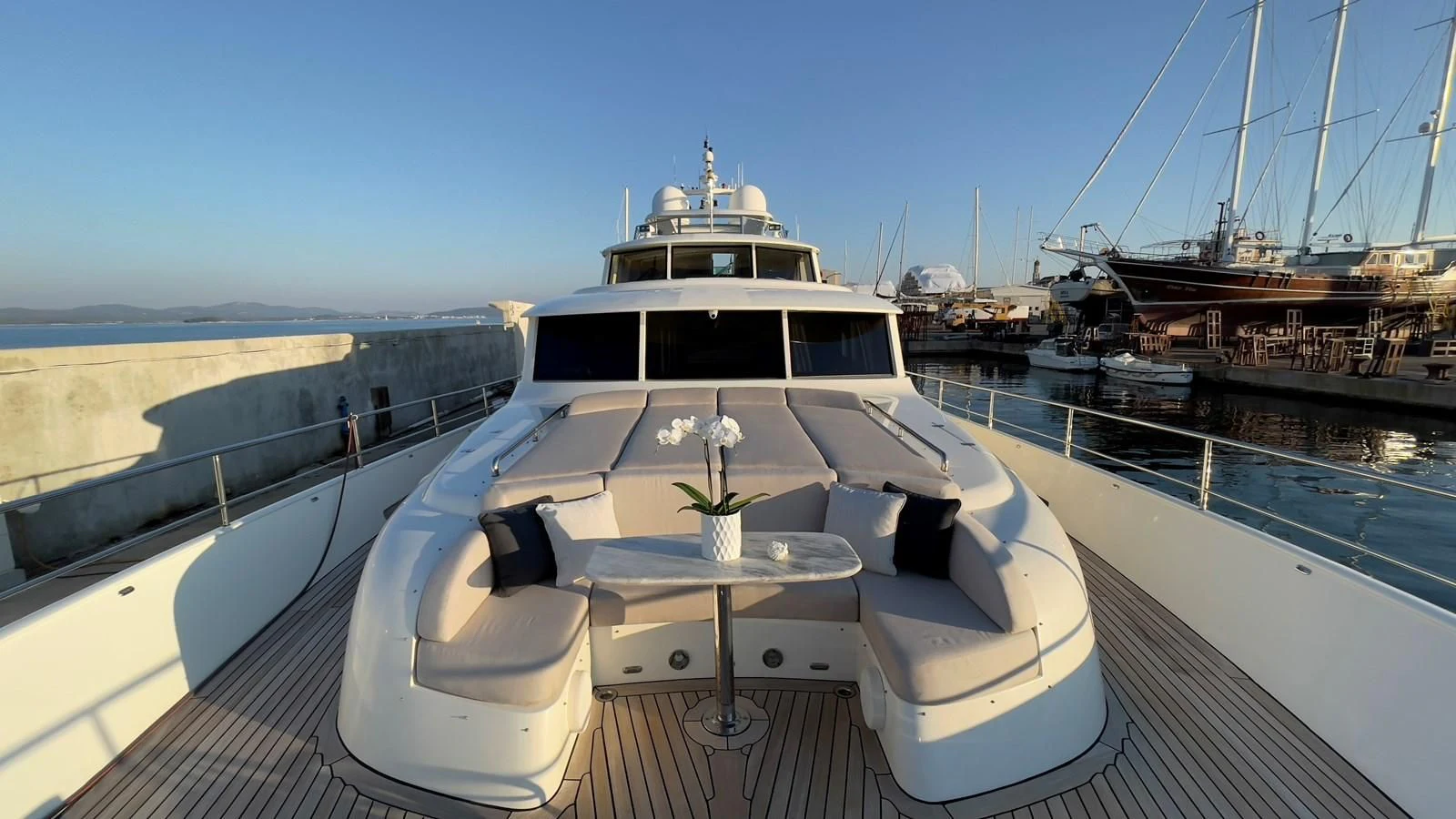 a large white yacht docked at a pier aboard CARPE DIEM Yacht for Sale
