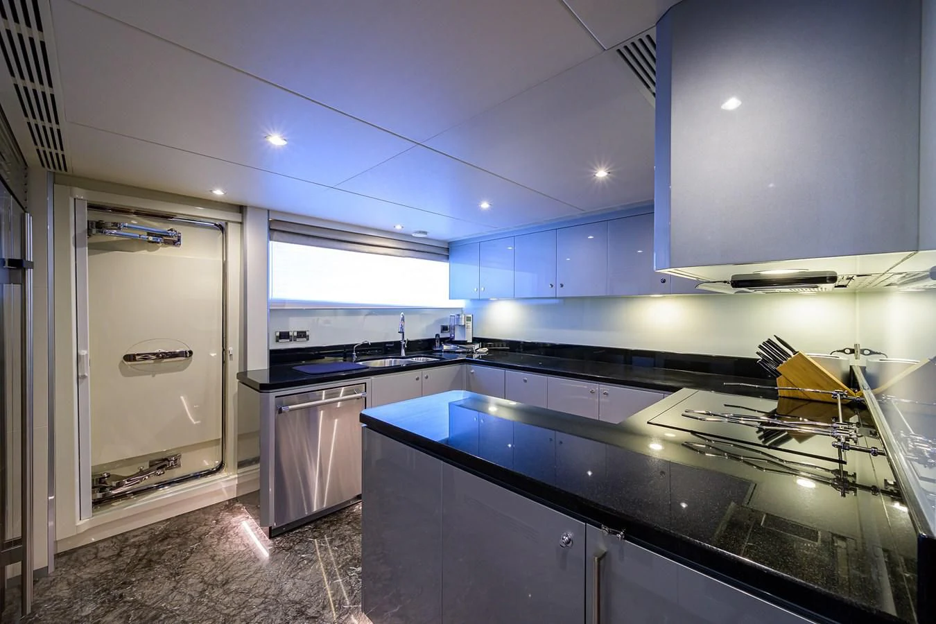 a kitchen with blue cabinets aboard ZEPHYR Yacht for Charter