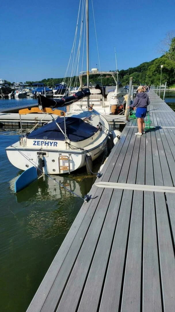 a person walking on a dock aboard ZEPHYR Yacht for Charter