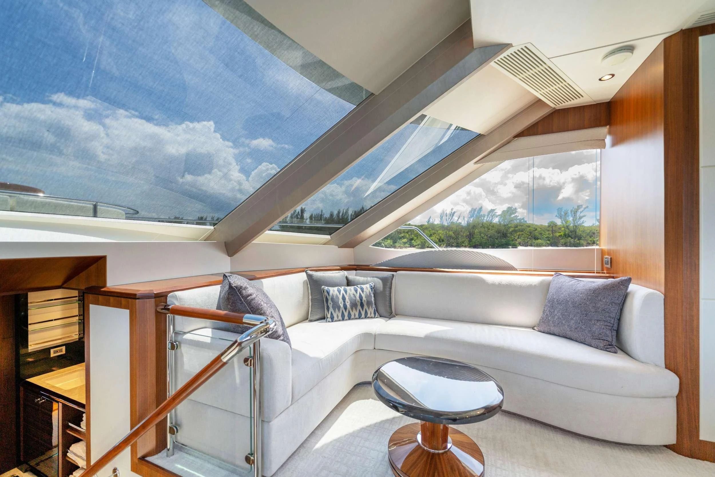 a room with a couch and a window aboard ZEPHYR Yacht for Charter
