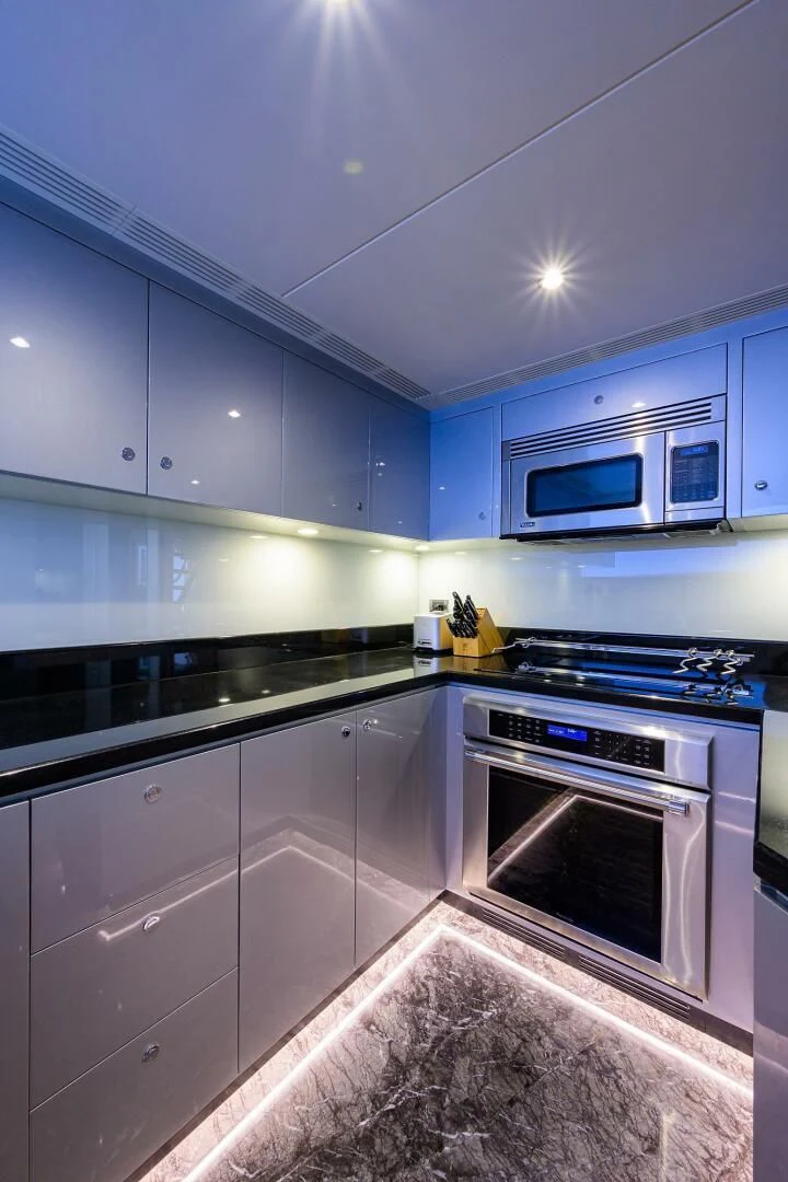 a kitchen with a stove and microwave aboard ZEPHYR Yacht for Charter