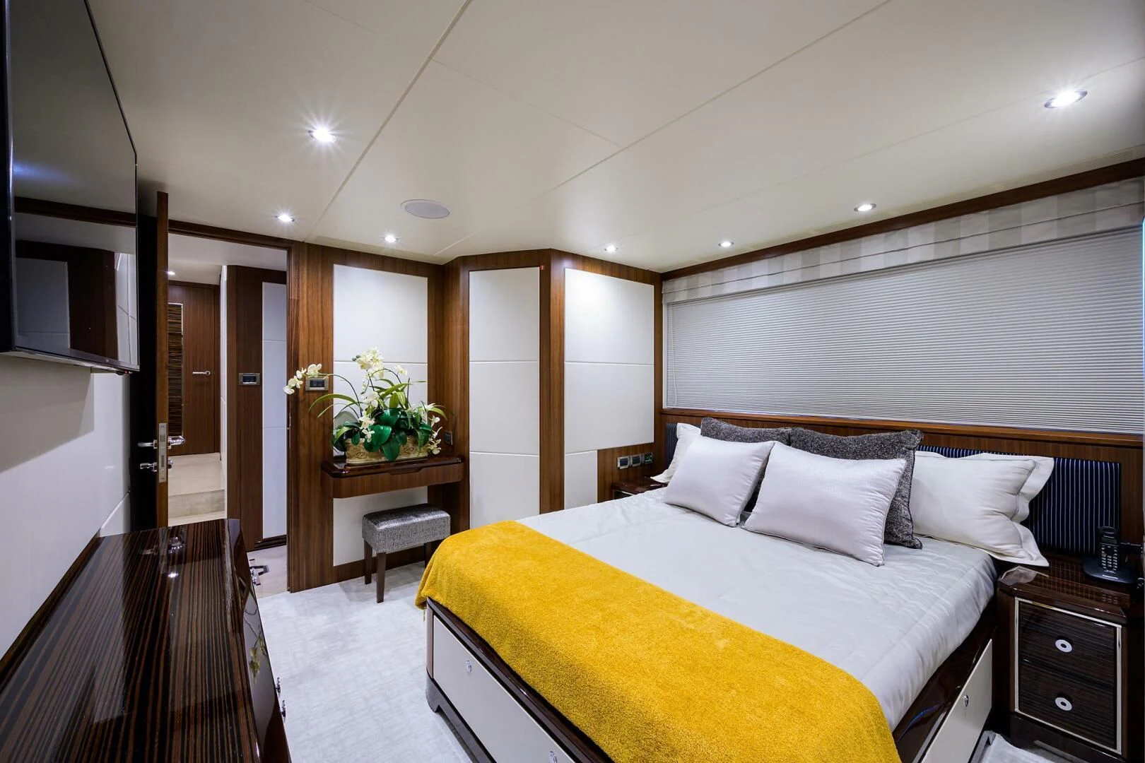 a bedroom with a bed and a desk aboard ZEPHYR Yacht for Charter