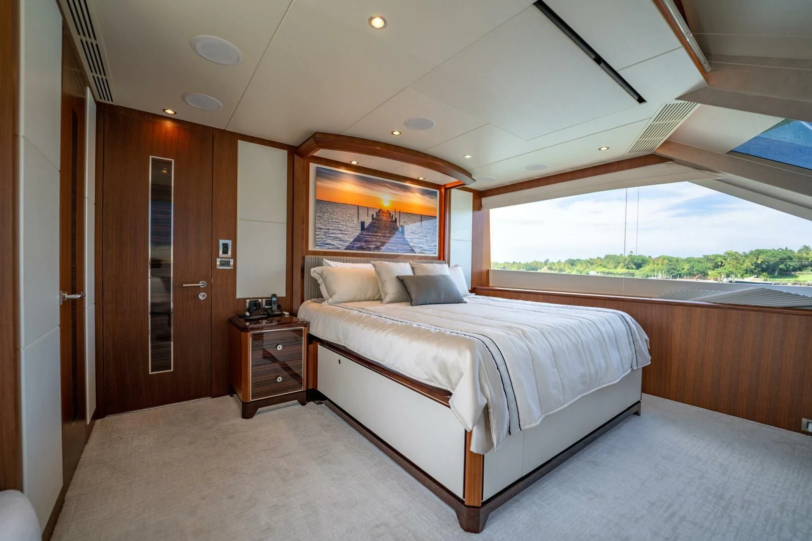 a bedroom with a bed and a wood cabinet aboard ZEPHYR Yacht for Charter