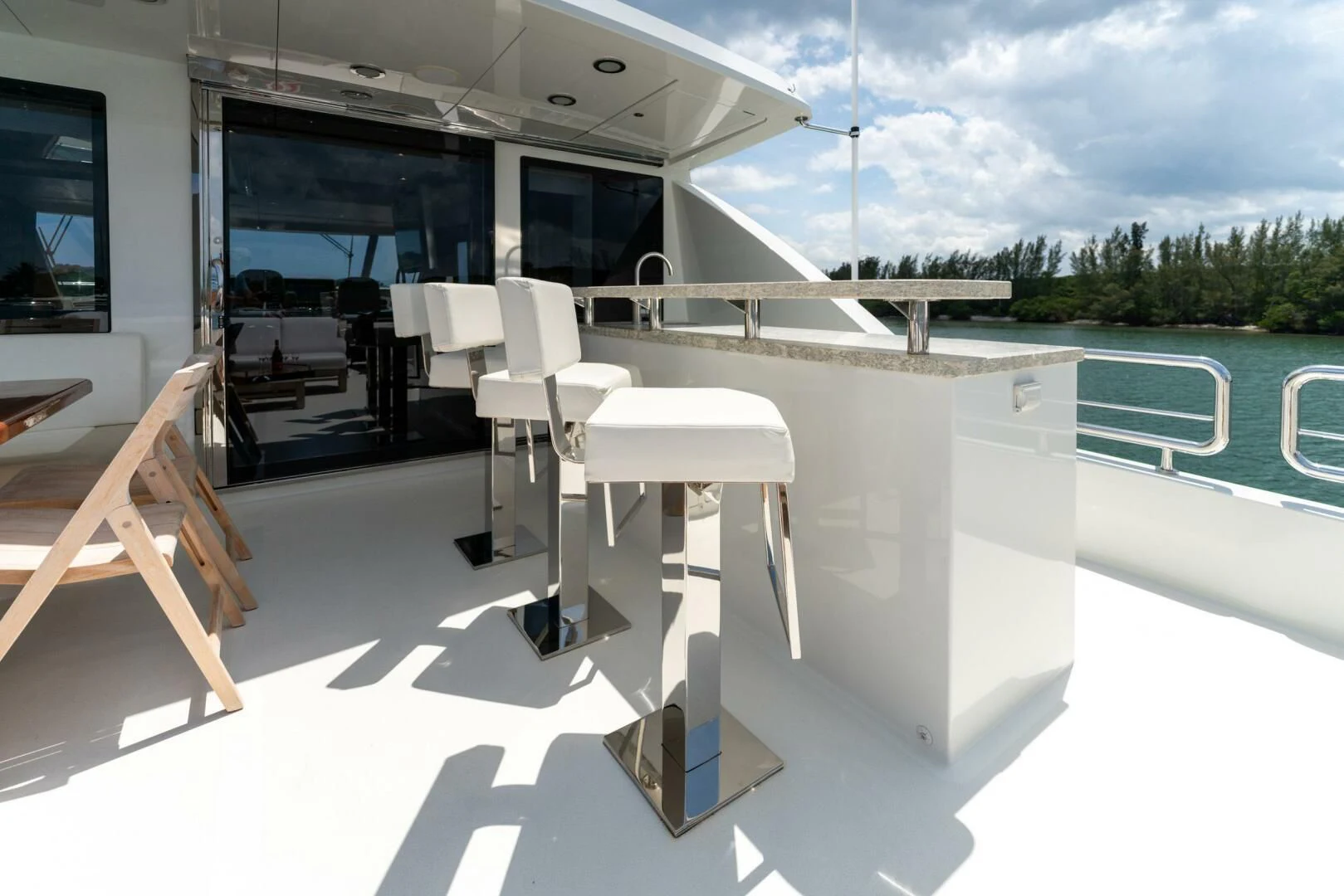 a room with a pool and chairs aboard ZEPHYR Yacht for Charter