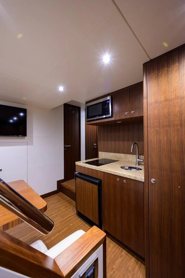 a kitchen with wooden cabinets aboard ZEPHYR Yacht for Charter
