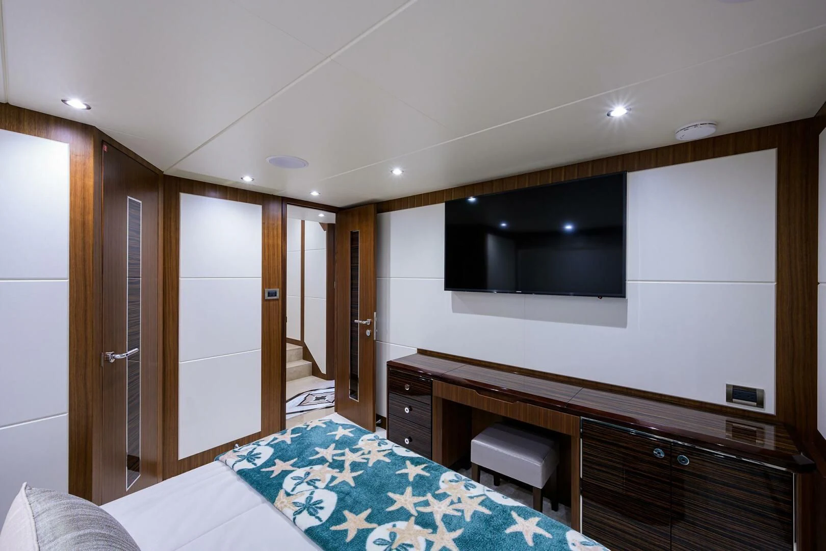 a bedroom with a bed and a television aboard ZEPHYR Yacht for Charter
