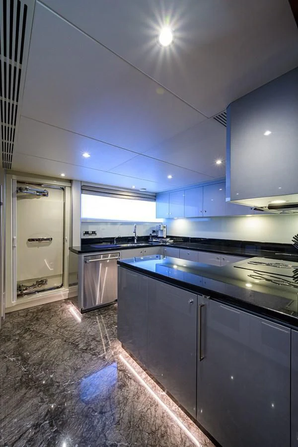 a kitchen with blue cabinets aboard ZEPHYR Yacht for Charter
