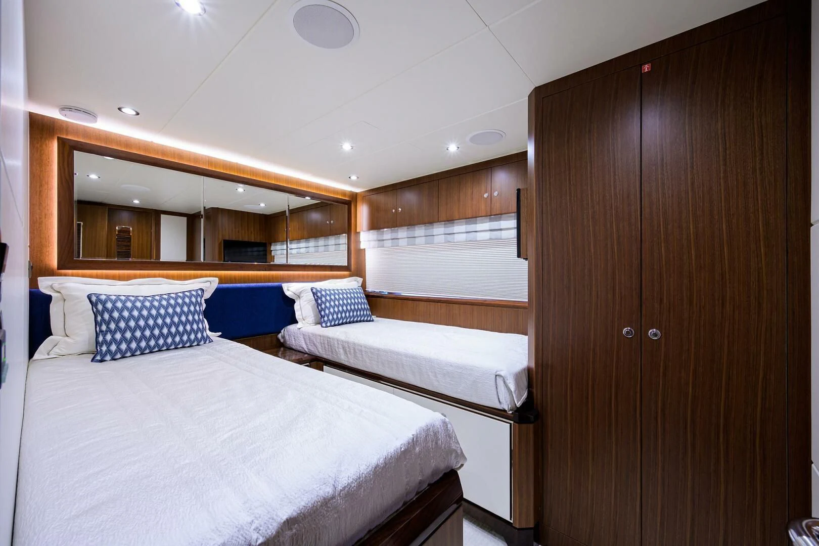 a room with a bed and a closet aboard ZEPHYR Yacht for Charter