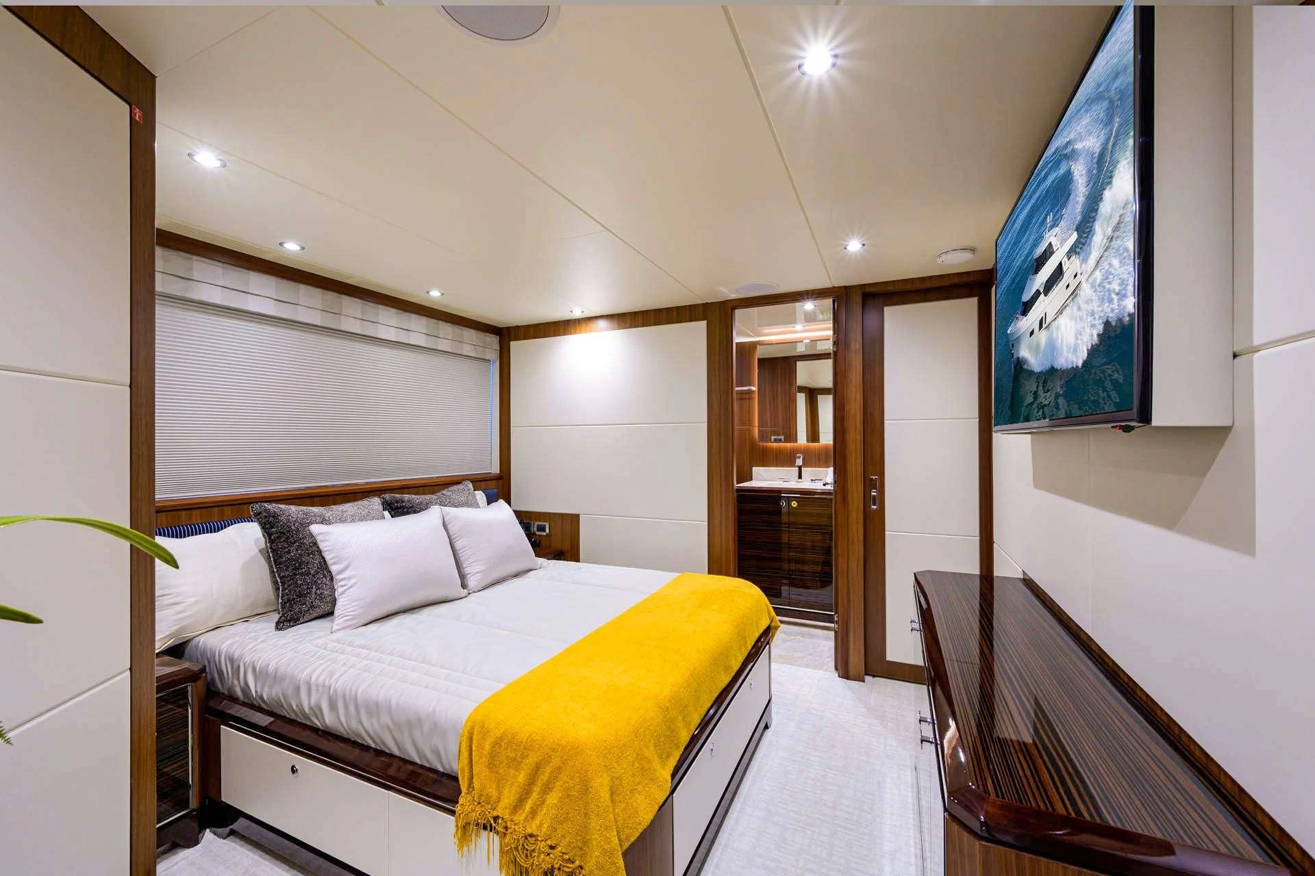 a room with a bed and a chair aboard ZEPHYR Yacht for Charter