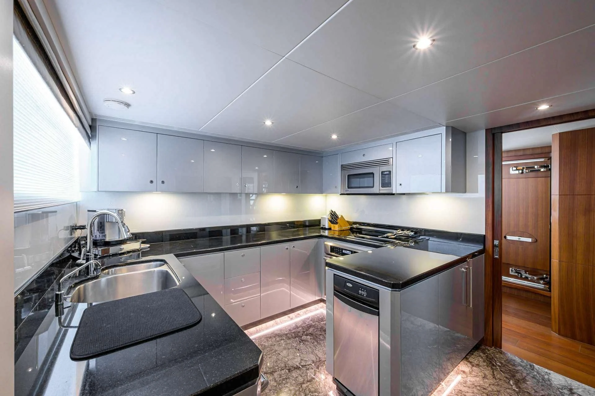a kitchen with white cabinets aboard ZEPHYR Yacht for Charter