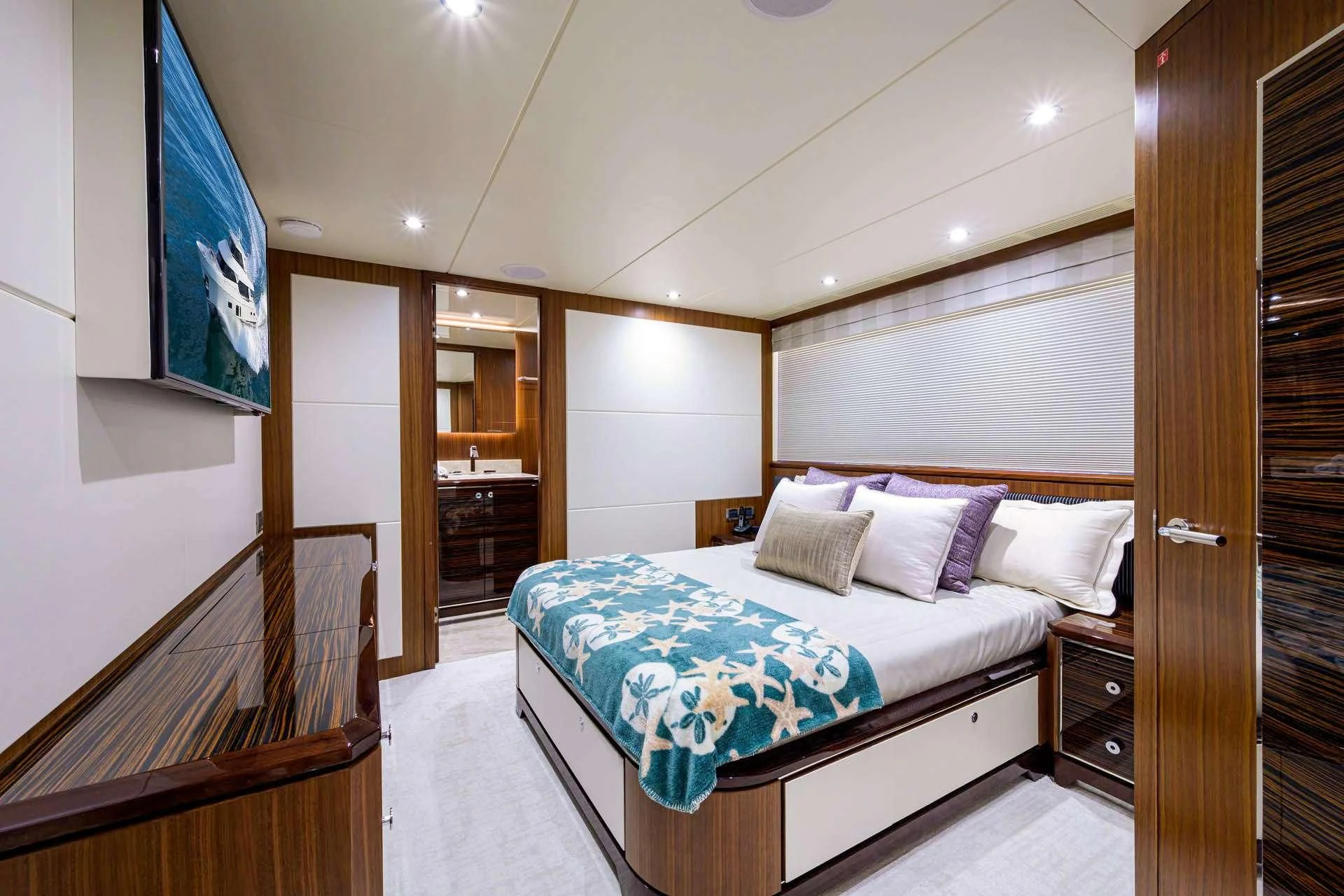 a bedroom with a bed and a door aboard ZEPHYR Yacht for Charter
