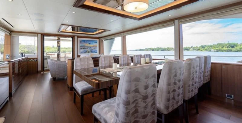 a dining room with a large window aboard ZEPHYR Yacht for Charter