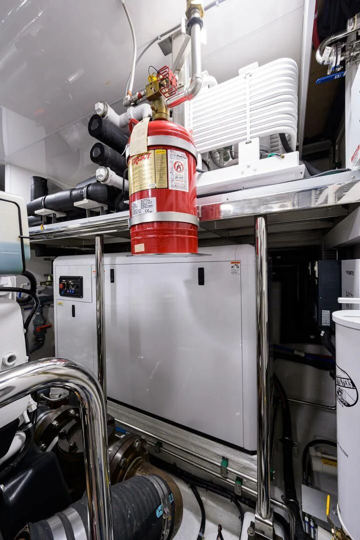 a red and white canister on a metal object in a factory aboard ZEPHYR Yacht for Charter