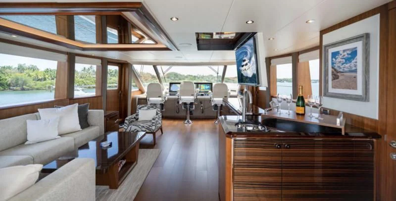 a living room with a large wood table and chairs aboard ZEPHYR Yacht for Charter