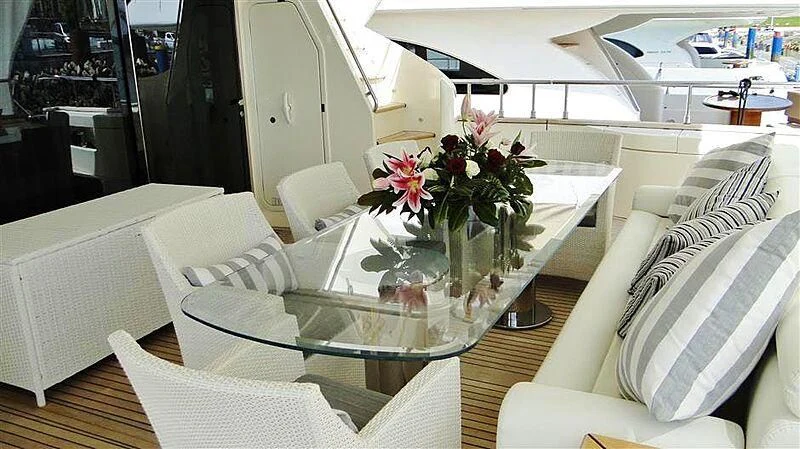 a room with a table and chairs aboard PRATA DO LYS Yacht for Sale