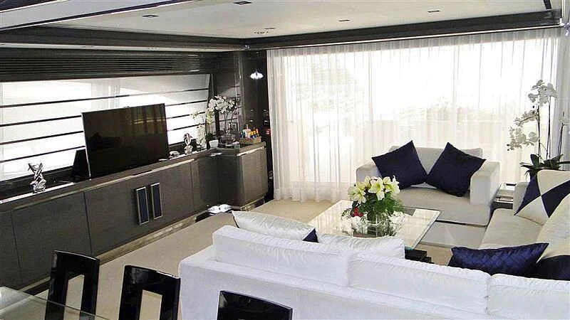 a living room with a white couch and a television aboard PRATA DO LYS Yacht for Sale