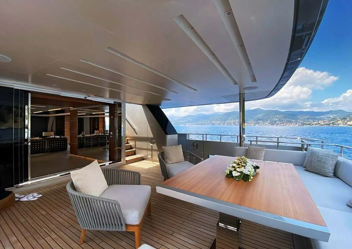 a large room with a table and chairs and a large body of water aboard LADY A Yacht for Sale