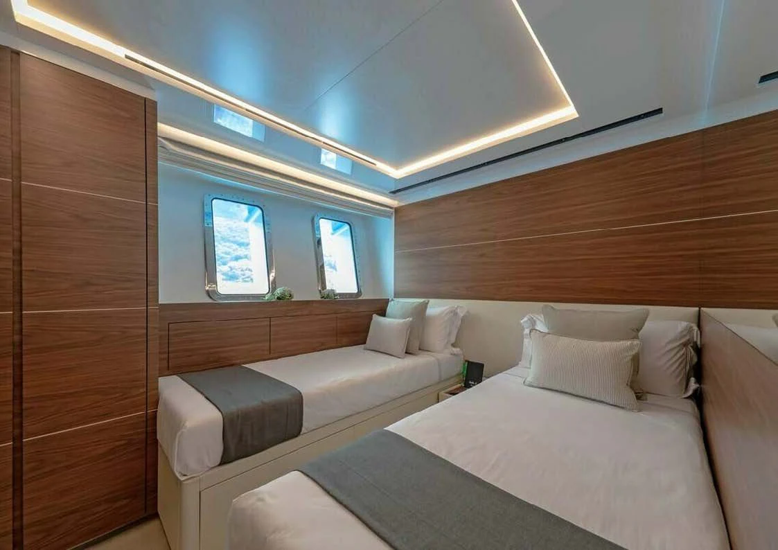 a room with a bed and a window aboard LADY A Yacht for Sale
