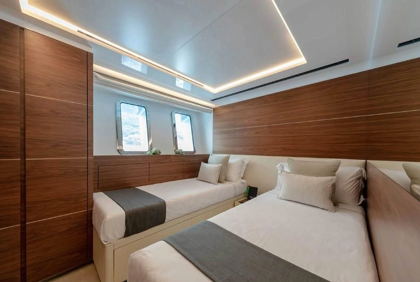 a room with a bed and a window aboard LADY A Yacht for Sale