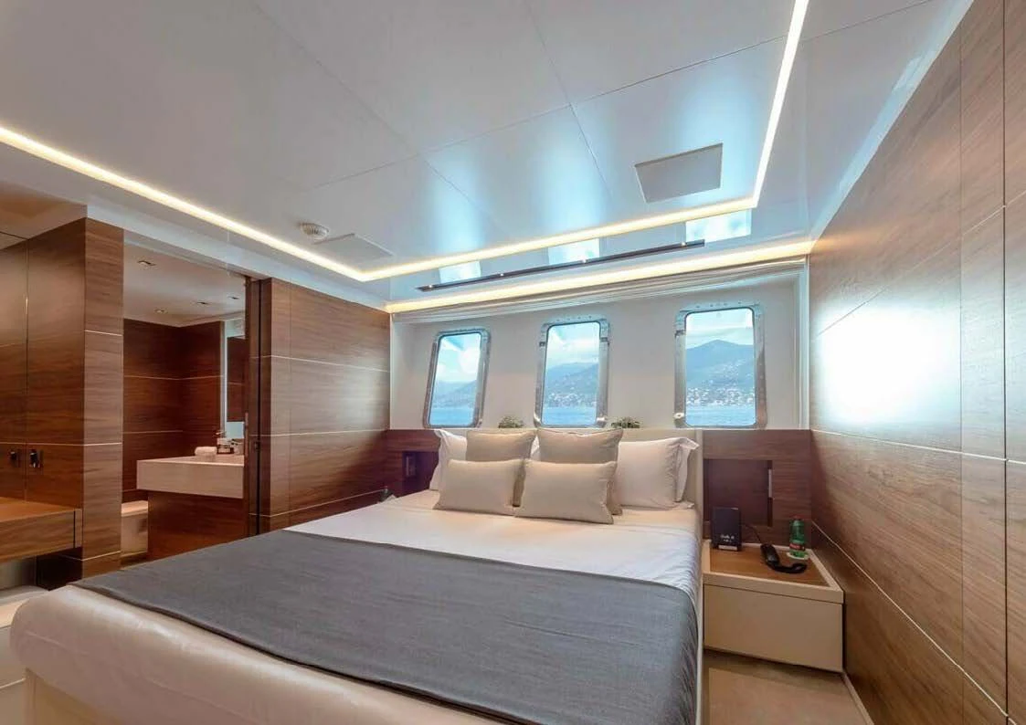 a room with a bed and a window aboard LADY A Yacht for Sale