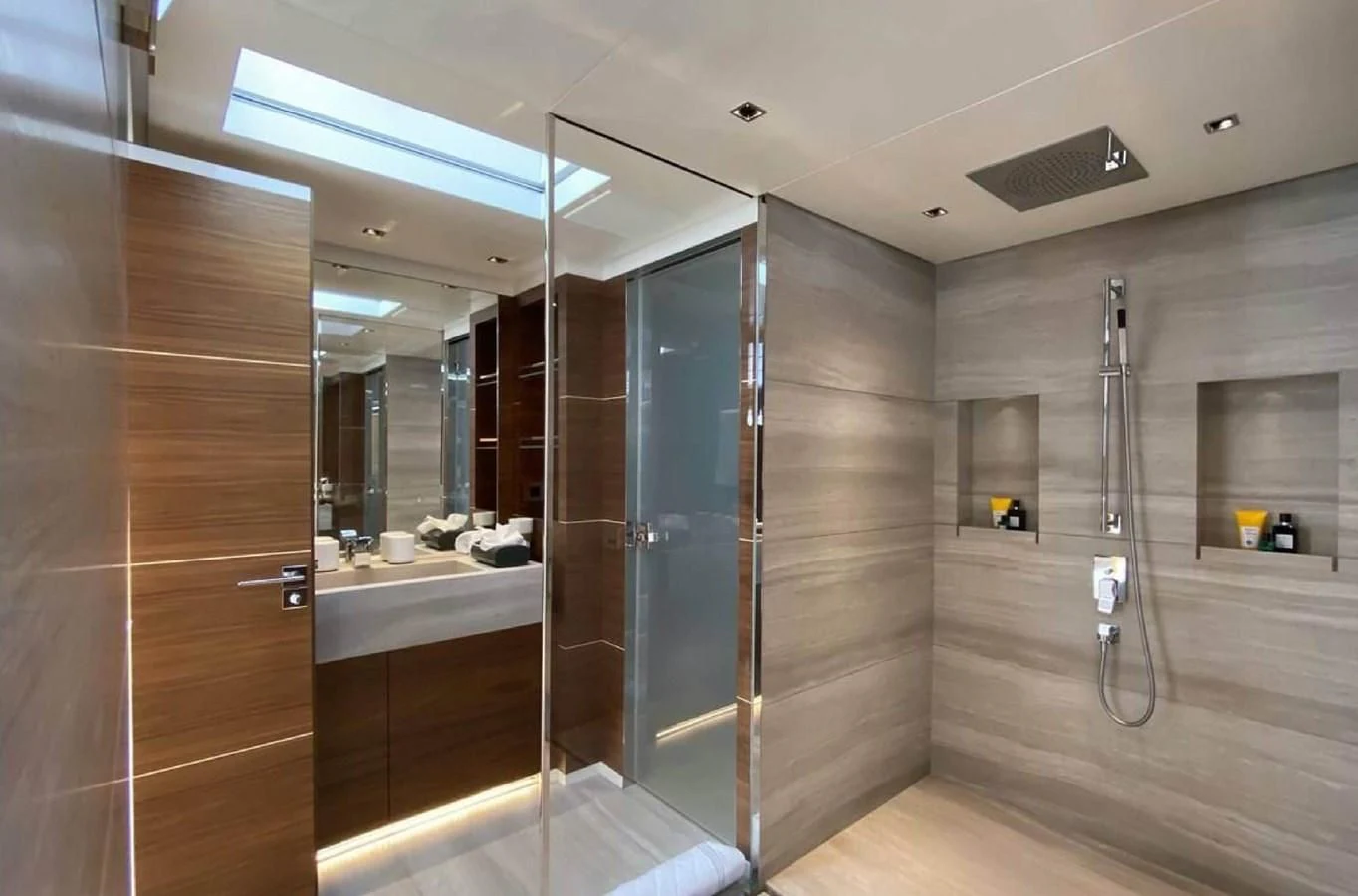a bathroom with a glass shower aboard LADY A Yacht for Sale