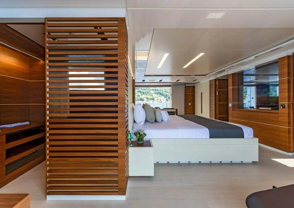 a bedroom with a bed and a large closet aboard LADY A Yacht for Sale