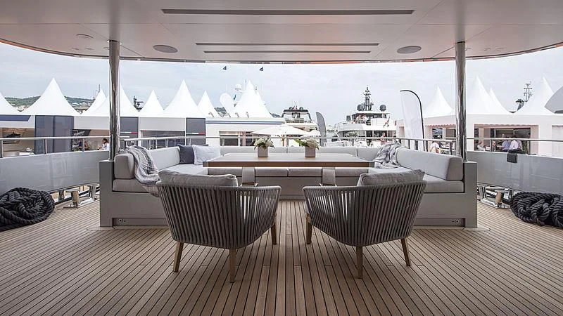 a large room with a couch and a table and chairs aboard LADY A Yacht for Sale