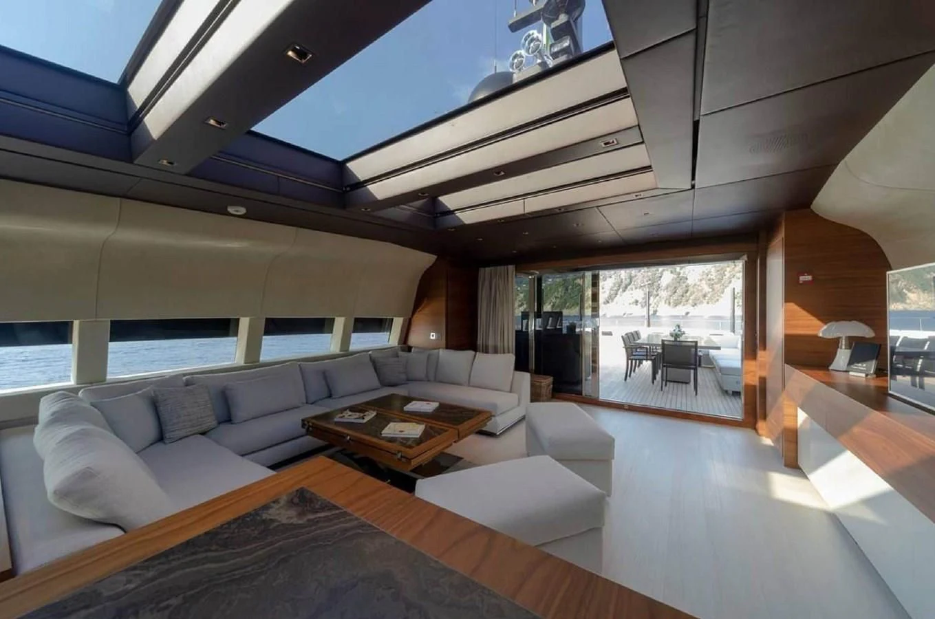 a modern living room with a large open window aboard LADY A Yacht for Sale