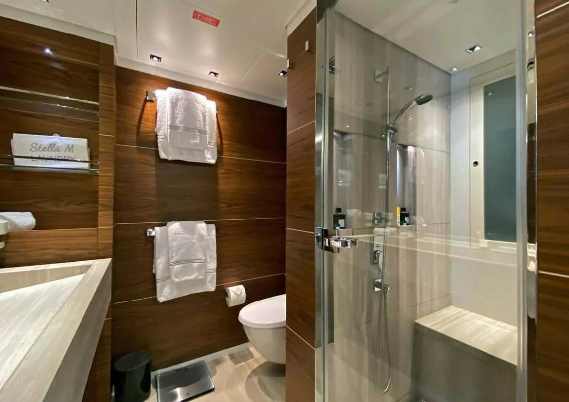 a bathroom with a glass shower aboard LADY A Yacht for Sale