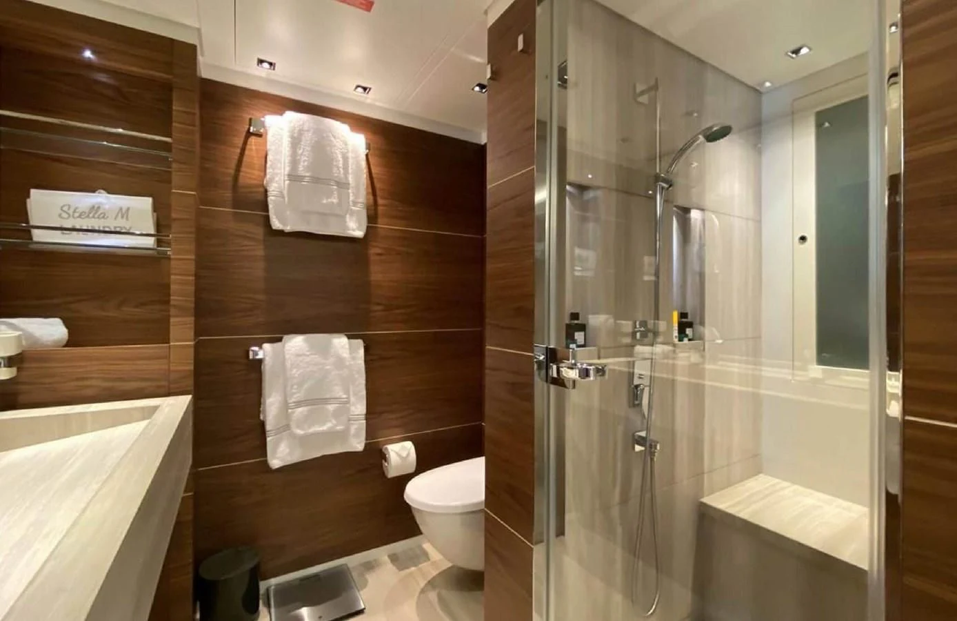 a bathroom with a glass shower aboard LADY A Yacht for Sale